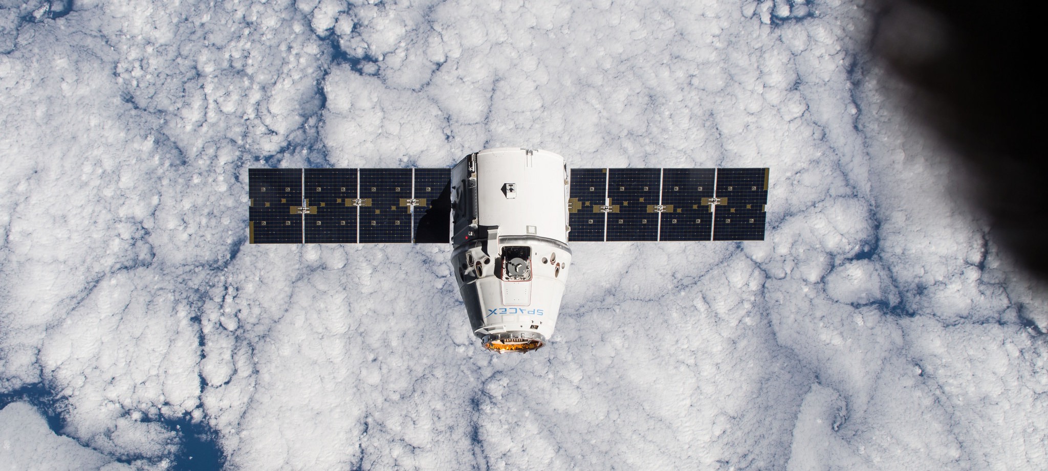 by one of the Expedition 42 crew members aboard the International Space Station, shows the SpaceX Dragon cargo craft approaching on Jan. 12 2015 - NASA Johnson
