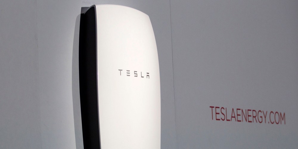 Tesla's newest product "Powerwall" is unveiled on stage in Hawthorne, Calif., Thursday, April 30, 2015. Tesla CEO Elon Musk is trying to steer his electric car company's battery technology into homes and businesses as part of an elaborate plan to reshape the power grid with millions of small power plants made of solar panels on roofs and batteries in garages. (AP Photo/Ringo H.W. Chiu)