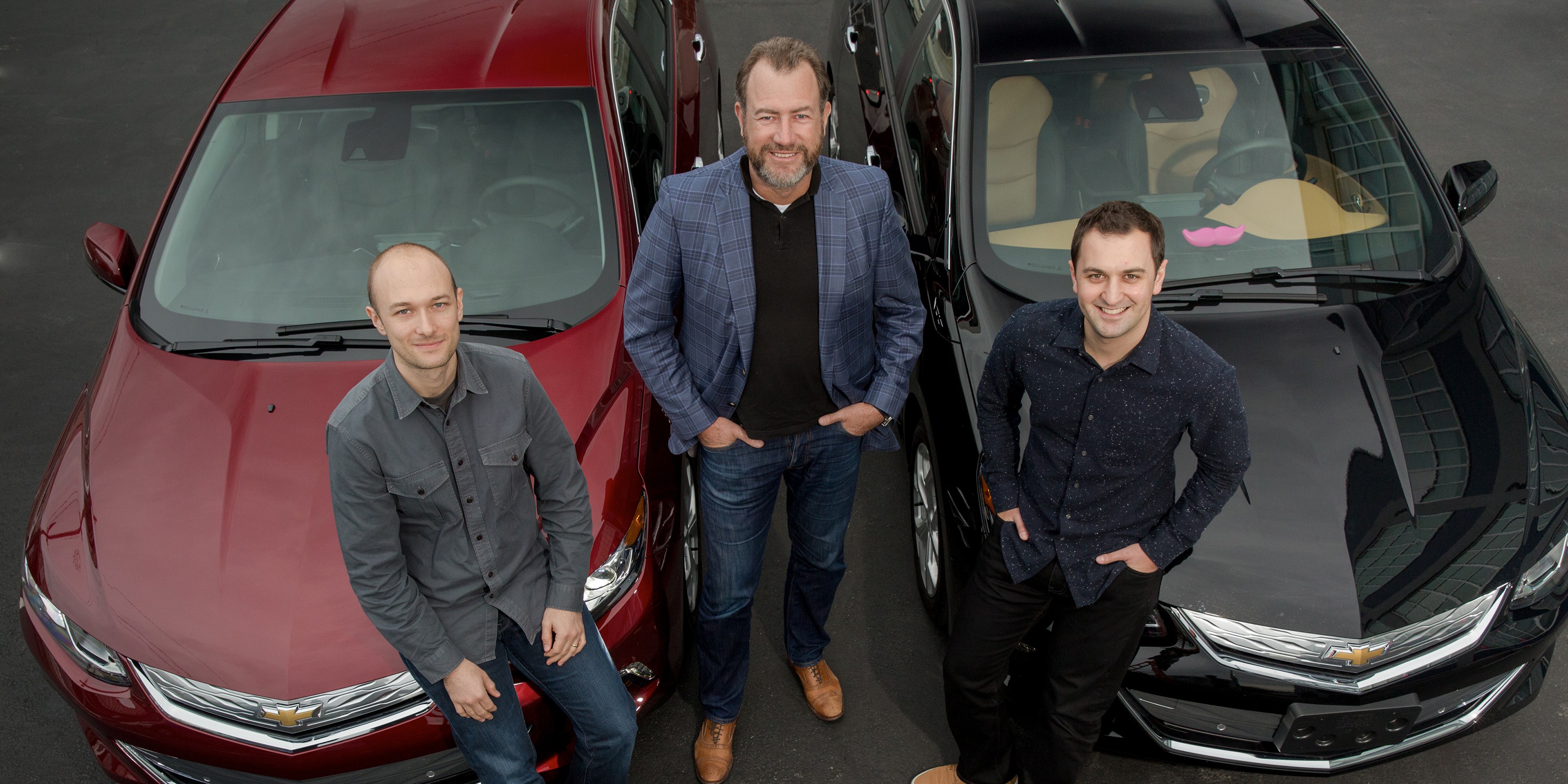 General Motors President Dan Ammann (center) with Lyft Inc. co-f