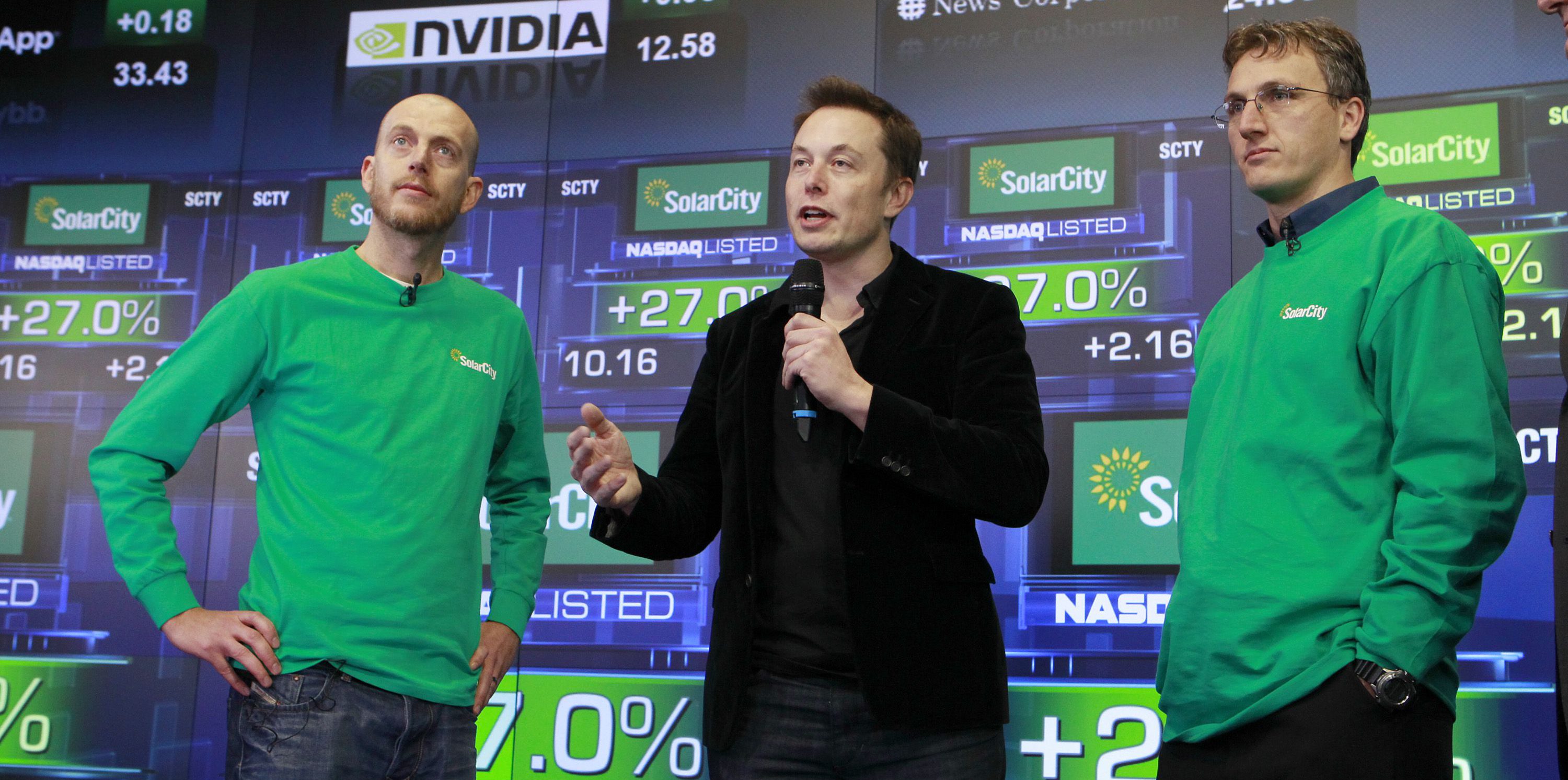 Founder & COO Peter Rive, Chairman Elon Musk , SolarCity Founder & CEO Lyndon Rive speak at the companys IPO at the NASDAQ stock exchange on December 13, 2012 in Manhattan, New York. SolarCity is a leader of distributed clean energy and will trade under SCTY. (Mark Von Holden/AP Images for SolarCity)