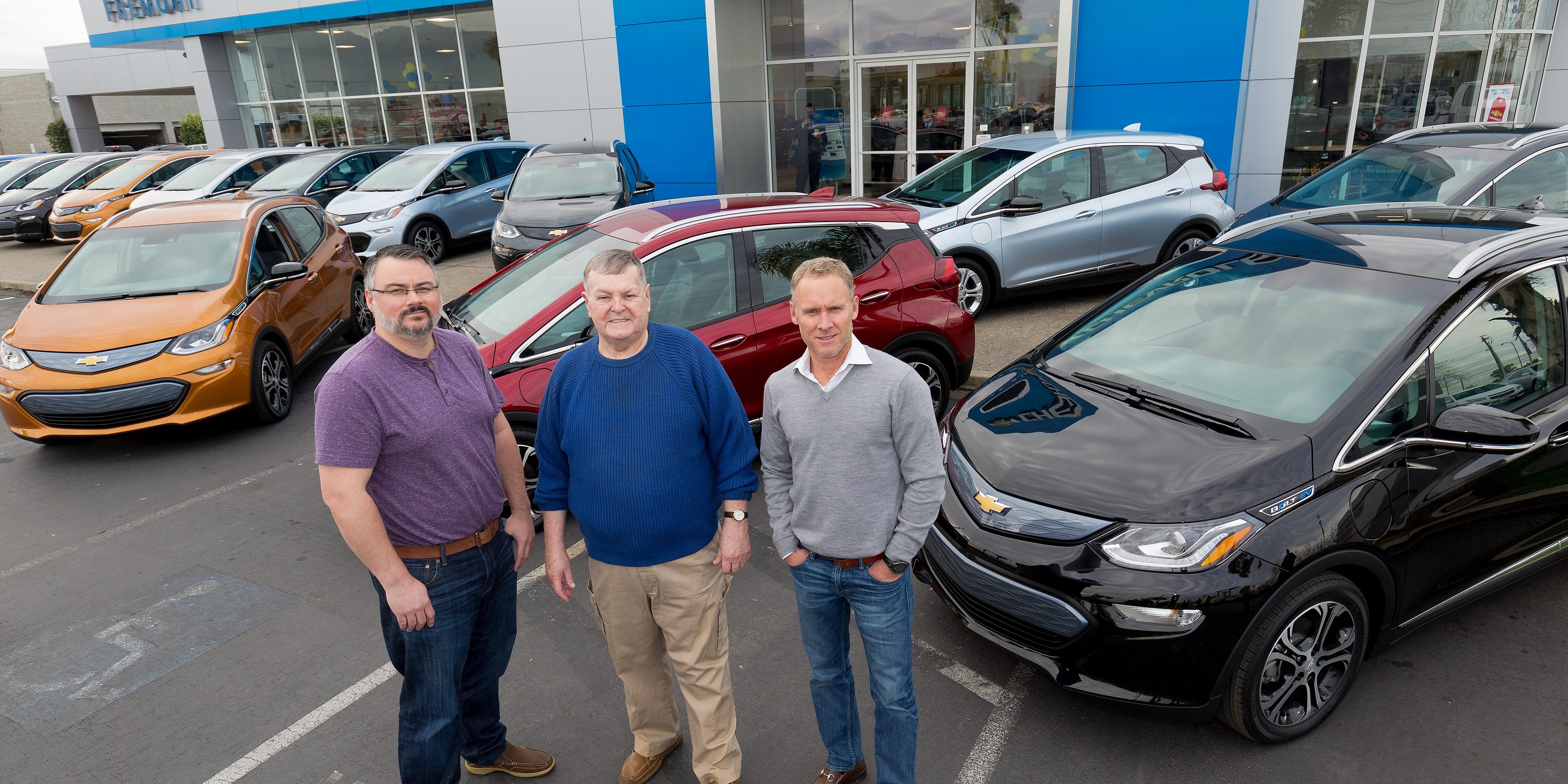 Customers Bobby Edmonds (l) of Castro Valley, CA, William “Bill” Mattos of Fremont, CA, and Steve Henry of Portola Valley, CA take delivery of the first three 2017 Chevrolet Bolt EVs Tuesday, December 13, 2016 at Fremont Chevrolet in Fremont, CA. The all-electric Bolt EV offers an EPA-estimated 238 miles of range on a full charge. (Photo by Martin Klimek for Chevrolet)
